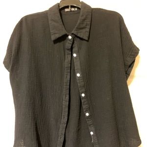 Women’s black button up collared shirt.